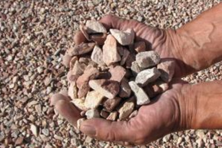 hands holding decorative gravel